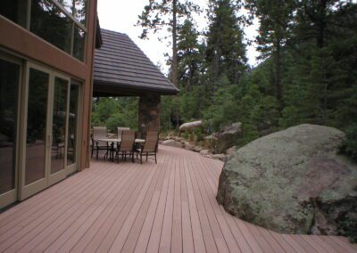 Deck outside home with Boulders