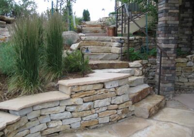 Siloam Stone Stepped Seating Wall and Stairway Leading Down Below Colorado Home